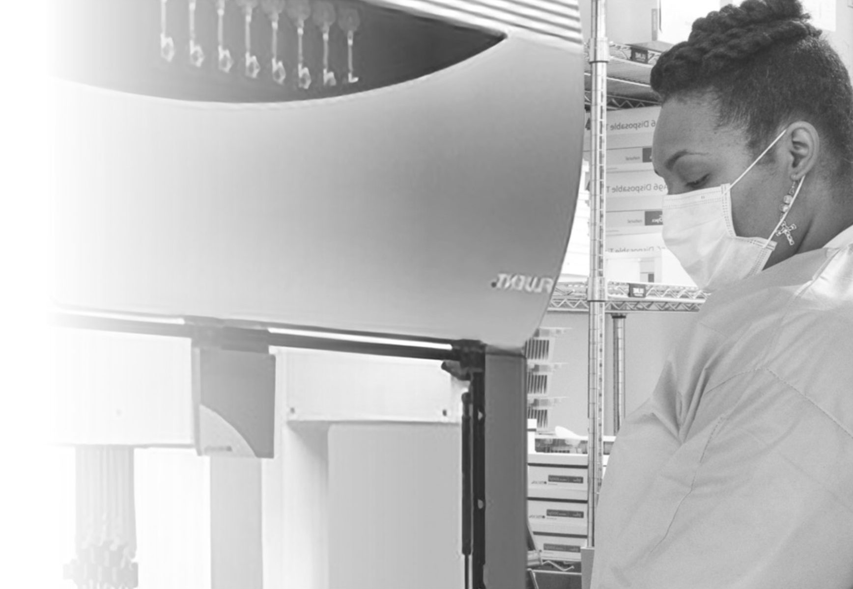 A Black woman wearing a face mask working in a laboratory