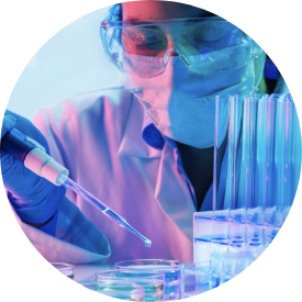 Photo of a masked technician working at a lab bench with test tubes and a pipette