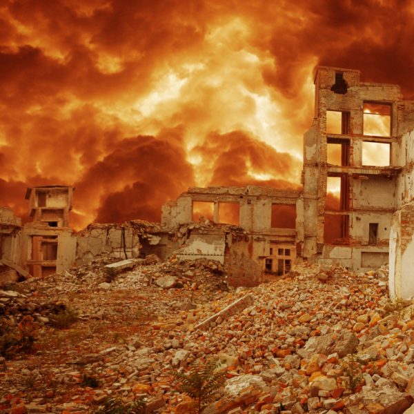 Photo of a war zone with explosions in the background.