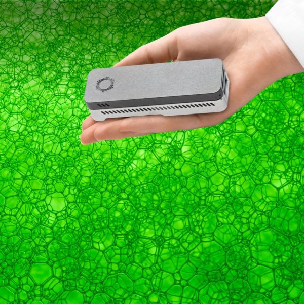 Hand holding the Oxford Nanopore MinION device in front of a green stylized "biological" background